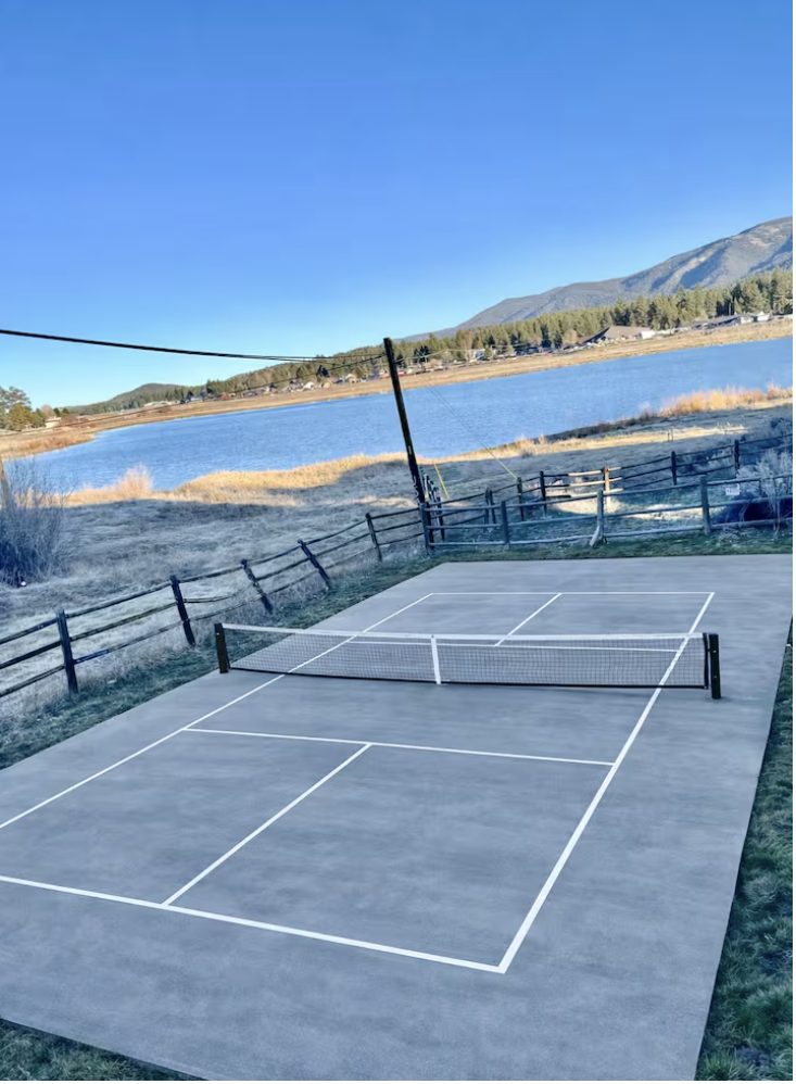 Private court with lake behind